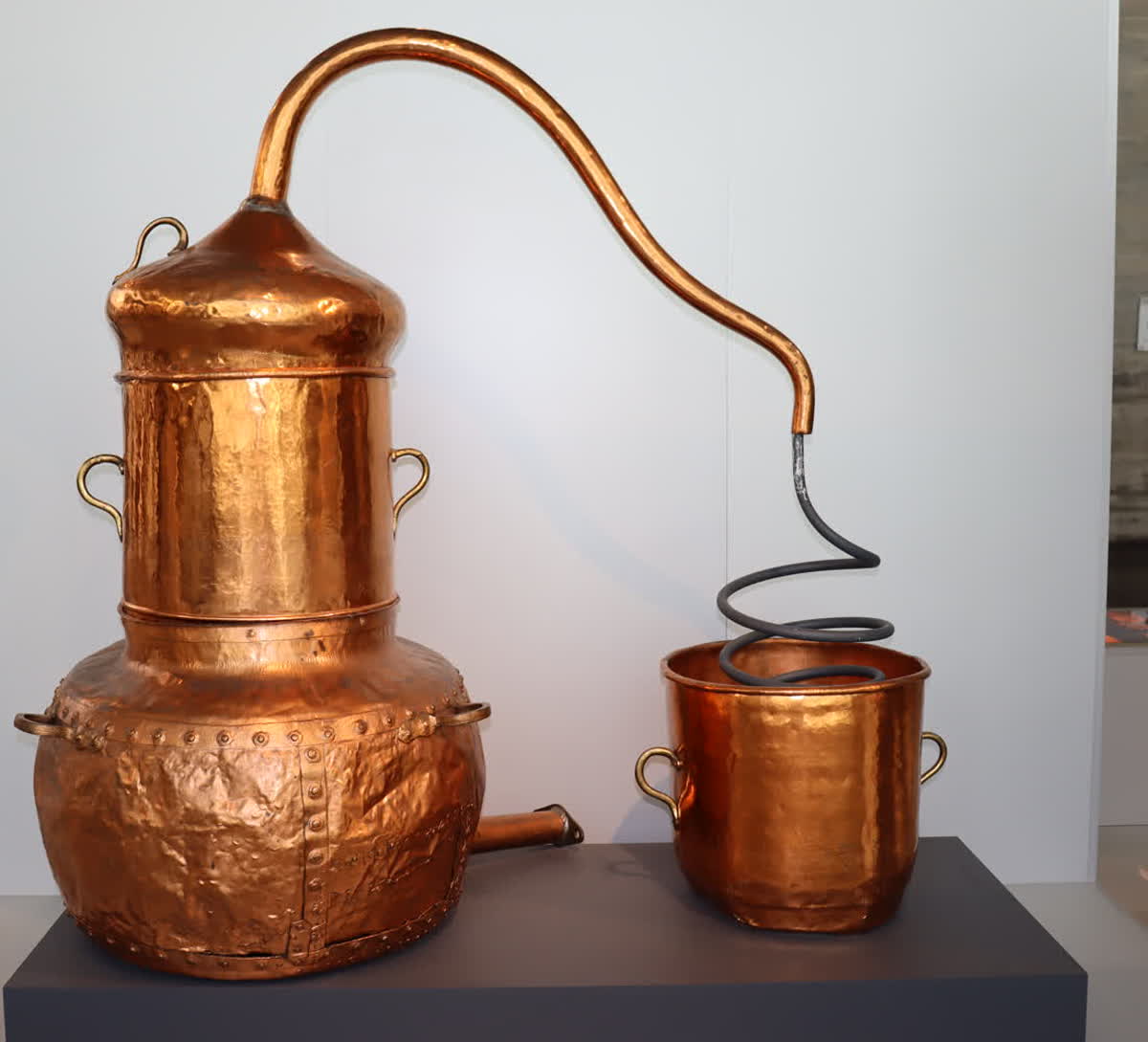 A traditional copper alembic still with coiled condenser used for steam distillation